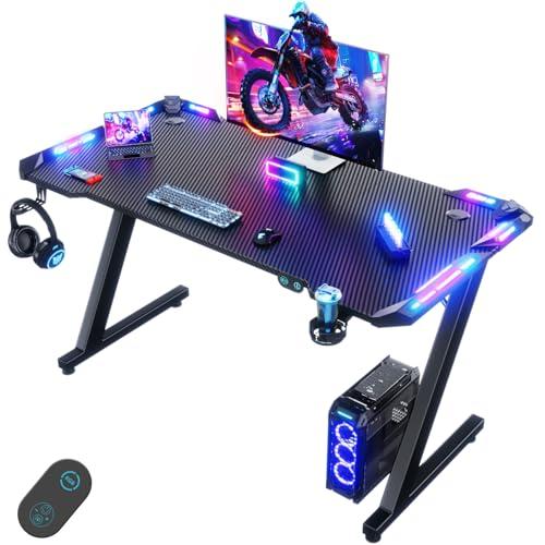 Devoko 120 x 60cm Scrivania Gaming LED, Tavolo Gaming Ergonomica, Scrivania per Computer con Porta Bicchiere e Ganci per Cuffie, Postazione con Piano del Tavolo in Fibra di Carbonio, Nero